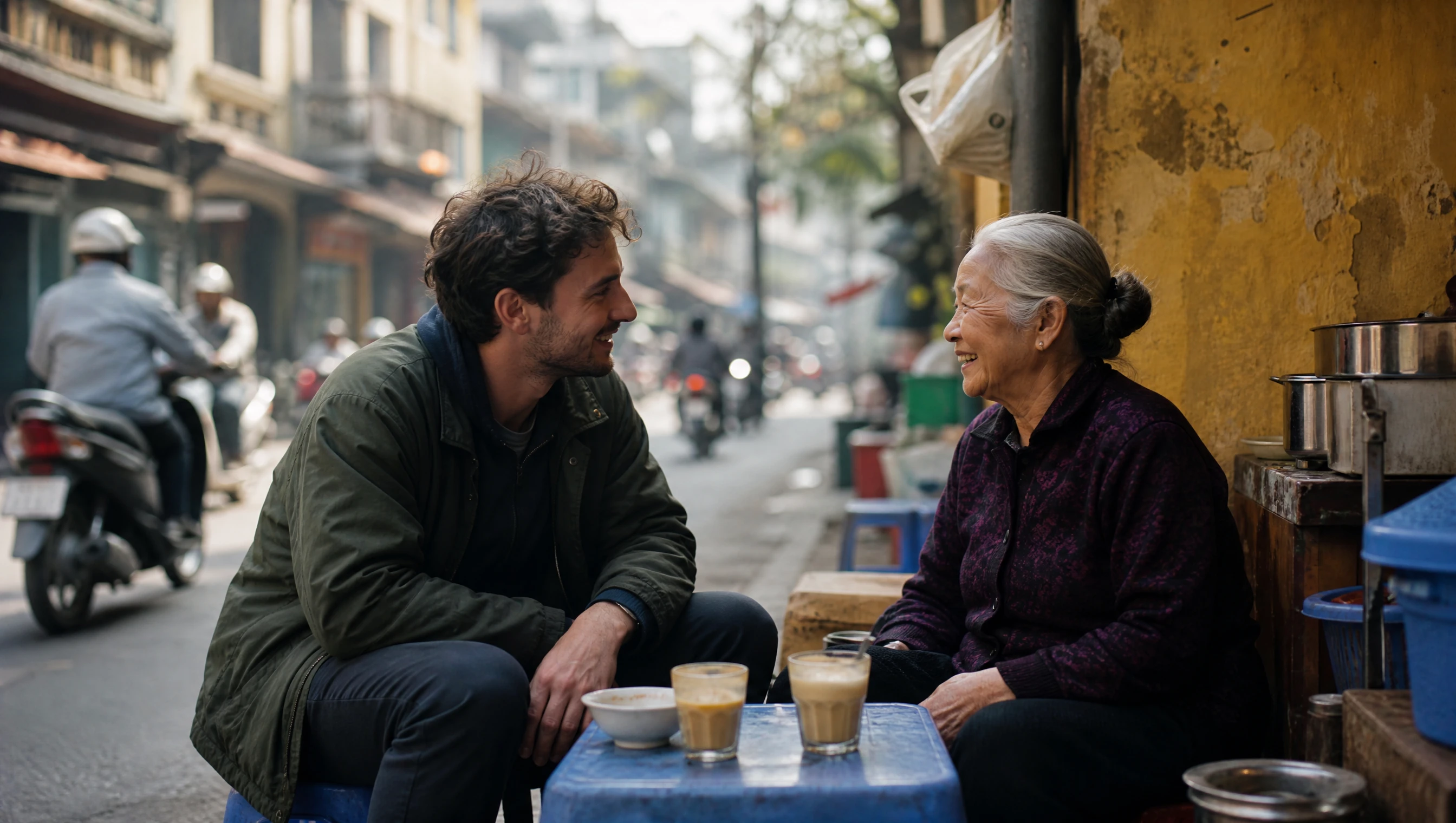 Traveler chatting with an elderly Vietnamese coffee stall owner on a Hanoi street